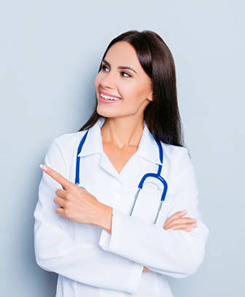 Smiling happy doctor pointing with finger on blue background